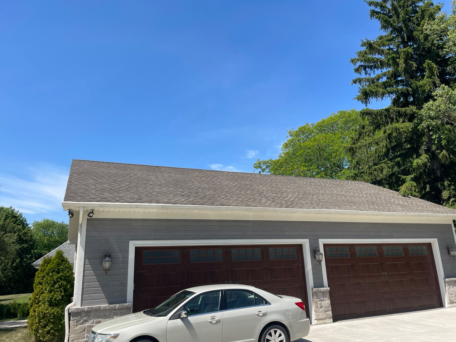 Asphalt shingle treatment project with visible roof surface